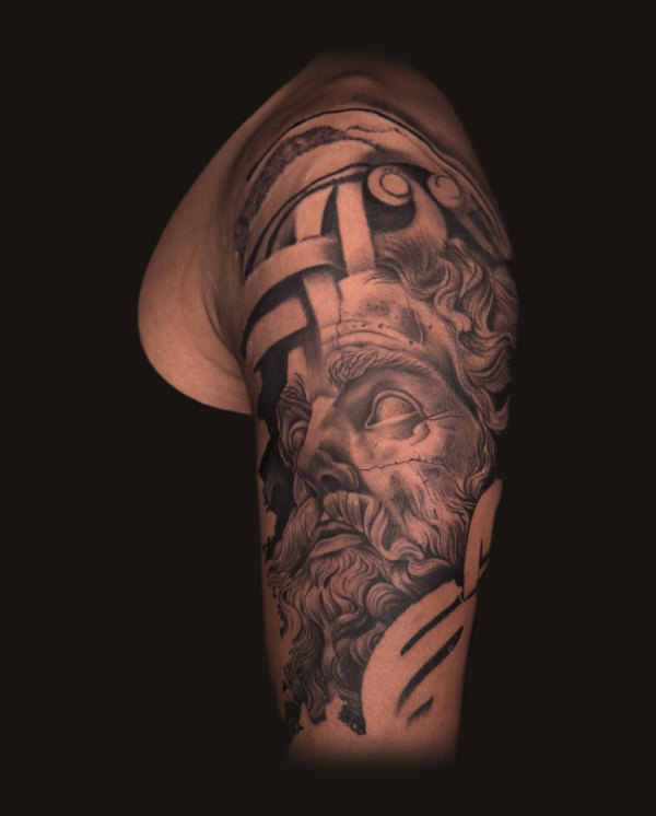 Zeus, a Greek deity statue portrait, black and grey realism tattoo on the upper arm